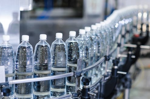image of water bottles on assembly line, with information on their data 