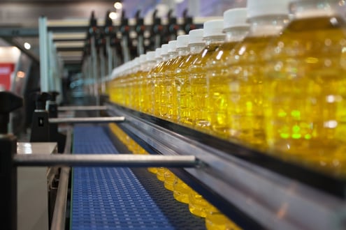 Images of yellow water bottles on assembly line 